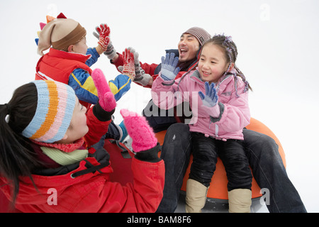 Les parents et les enfants équitation sur Snow Tube gonflable Banque D'Images