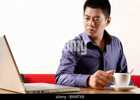 L'homme de prendre Pause de Using Laptop Banque D'Images