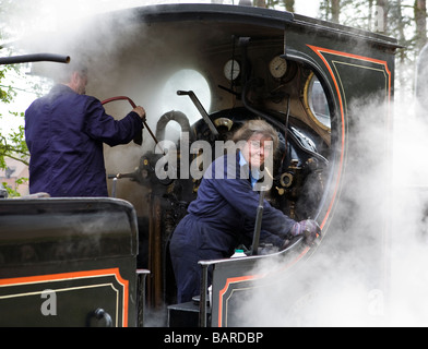 La dame bénévole 'pompier' d'un l&Y locomotive à vapeur vu à Weybourne station sur le chemin North Norfolk Banque D'Images