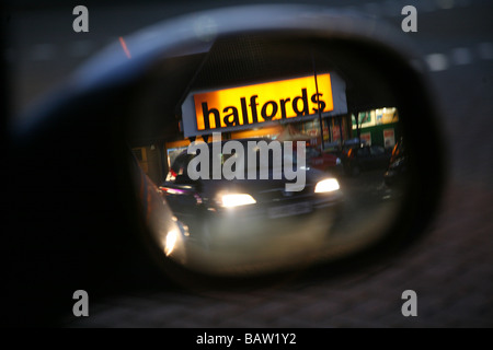 Un magasin de pièces de voiture Halfords reflétée dans un miroir de voiture. Cette image a été inversée. Banque D'Images
