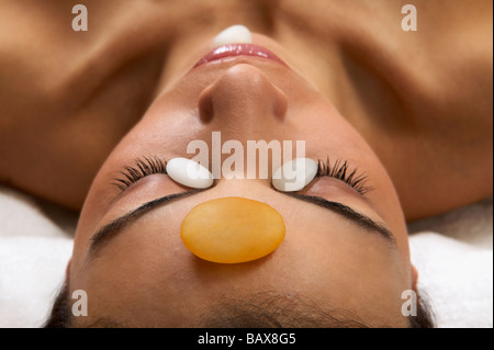 Close up of young woman receiving stone spa treatment Banque D'Images