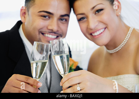 Multi-ethnic Bride and Groom toasting Banque D'Images