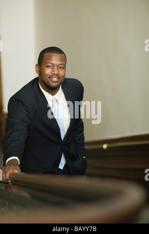 African businessman ascending staircase Banque D'Images