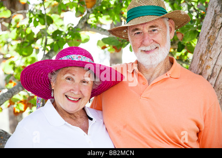 Sweet couple leurs chapeaux soleil en vacances Banque D'Images