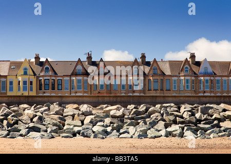 Maisons protégées par un mur de défense de la mer la mer et les rochers de granit à Withernsea, East Yorkshire, England, UK Banque D'Images