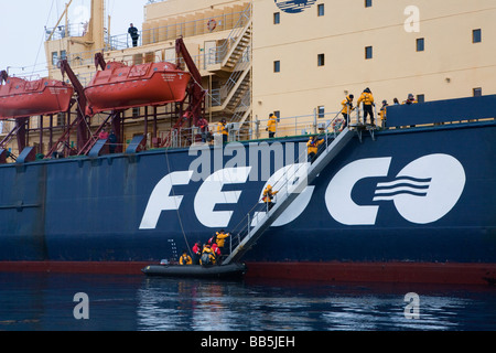 Les passagers de croisière vacances expédition dans l'ouest de l'Antarctique grimper à bord de brise-glace russe passerelle bateau de croisière après zodiac petite excursion en bateau. Banque D'Images