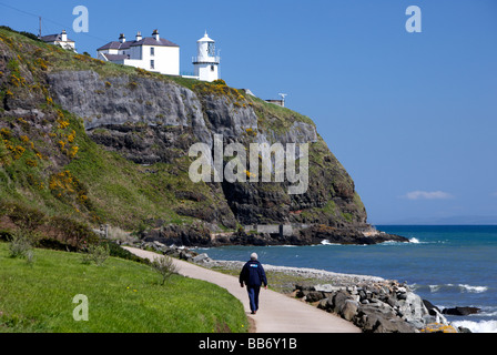 Phare de point noir et l'homme qui marche le long de la whitehead à tête noire chemin côtier le comté d'Antrim en Irlande du Nord uk Banque D'Images