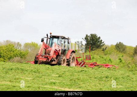 Le tracteur et l'ensilage fanage Pembrokeshire Wales Cymru Machine Bosherston UK Banque D'Images