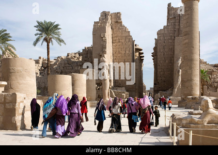 Grande cour et deuxième pylône, femme les visiteurs portant des vêtements traditionnels, Temple d'Amon-Rê, le Temple de Karnak, Louxor, Egypte, Afr Banque D'Images