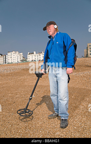 La détection de métal d'un homme sur la plage de Brighton en essayant de trouver de l'argent Banque D'Images