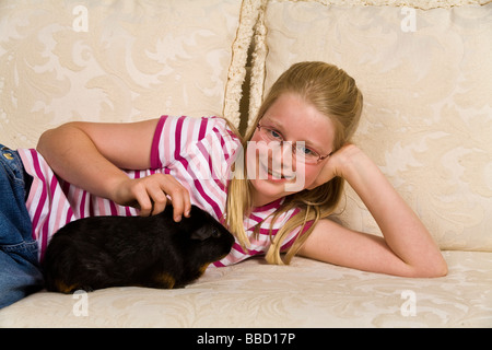 Young Caucasian 10-11 ans ans girl holding sa Myrleen cobaye MR © Pearson Banque D'Images