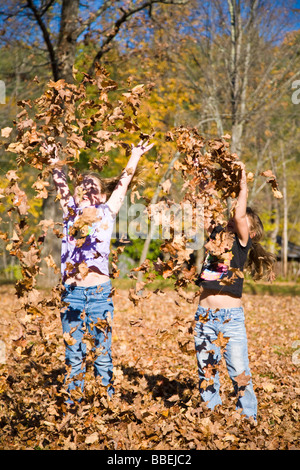 De jeunes filles, jouant dans les feuilles d'automne, Grafton, Massachusetts, USA Banque D'Images