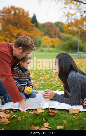 Séance familiale sur une couverture dans un parc en automne, Portland, Oregon, USA Banque D'Images