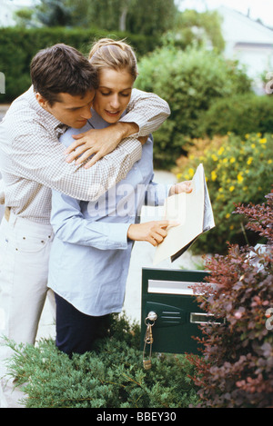 Couple checking mail ensemble, couple de derrière Banque D'Images