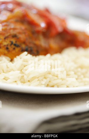 D'authentiques plats préparés Poulet au Curry Rouge Thaï épicé avec des poivrons rouges et riz parfumé isolé sur un fond blanc avec aucun peuple Banque D'Images