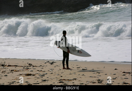 Surfer à Portreath beach, Cornwall, England, UK Banque D'Images