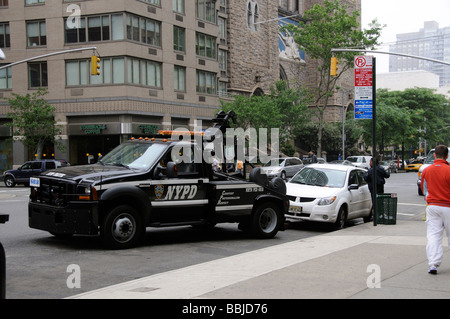 Stationnement en infraction le NYPD remorquer le chariot et policière de la tentative d'entrer dans la voiture, New York USA Banque D'Images