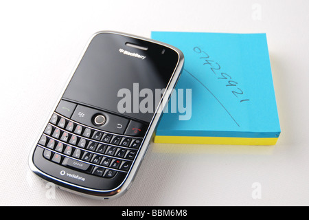 900 Blackberry Bold et bloc-notes sur fond blanc Banque D'Images