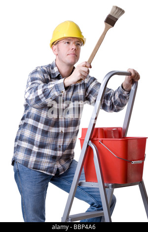 Studio photo de plein isolé un jeune artisan sur une échelle à l'aide d'un pinceau Banque D'Images