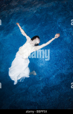 Girl floating in water Banque D'Images