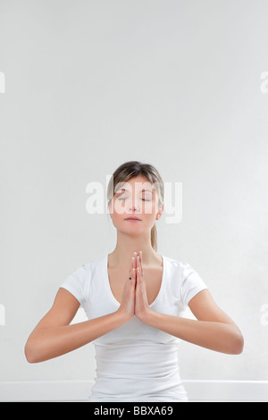 Young woman doing yoga indoors Copy space Banque D'Images