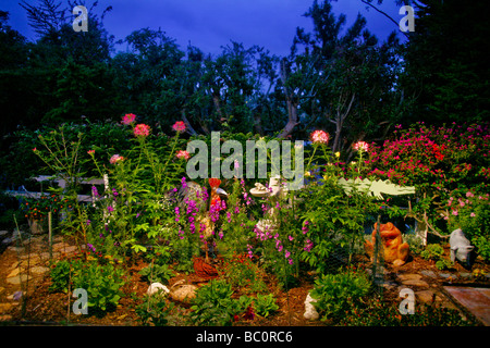 Les chiffres d'un coq amusant, grenouille ailée, et l'hippopotame décorer un jardin du sud de la Californie au crépuscule. Banque D'Images