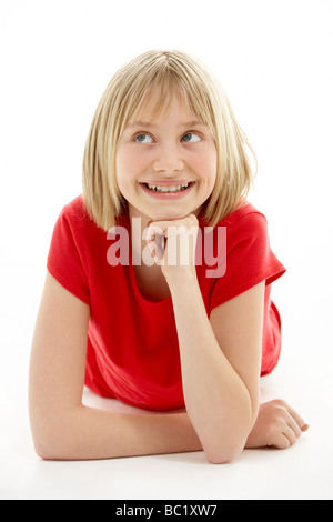 Young Girl Lying On Stomach In Studio Banque D'Images