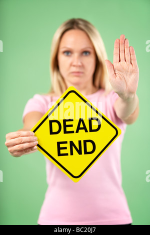 Woman Holding Road Traffic Sign Banque D'Images