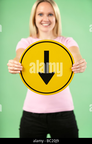 Woman Holding Road Traffic Sign Banque D'Images