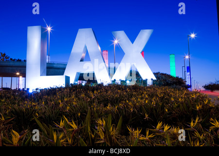 Signe tridimensionnel énonçant "LAX" à l'entrée de l'Aéroport International de Los Angeles à Los Angeles, Californie, au crépuscule. Banque D'Images