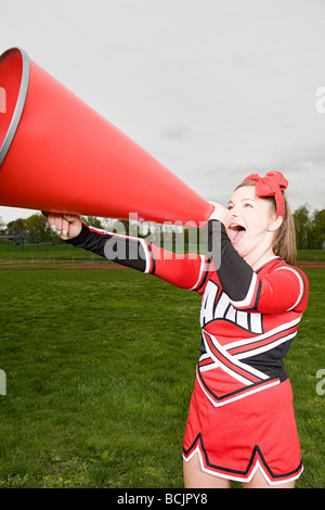 Cheerleader with megaphone Banque D'Images