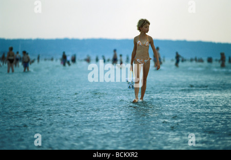 Girl walking on beach, godet holding
