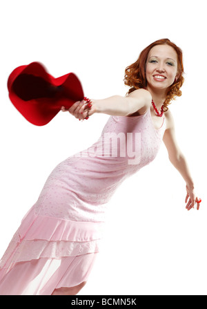 Young smiling woman throwing a red hat Banque D'Images