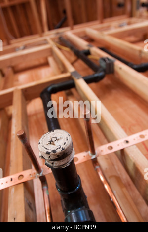 Les tuyaux de plomberie et de vidange installé dans un mur à l'emplacement de la construction résidentielle Banque D'Images