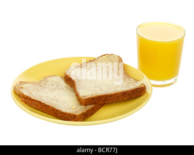 Le pain brun avec du beurre et du jus d'Orange Banque D'Images