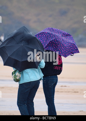 Deux femmes sur la plage un jour venteux et humide Banque D'Images