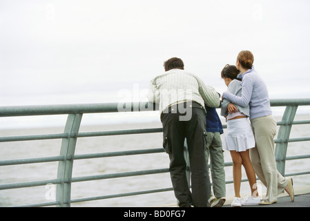 Famille ensemble à seawall railing looking at view Banque D'Images