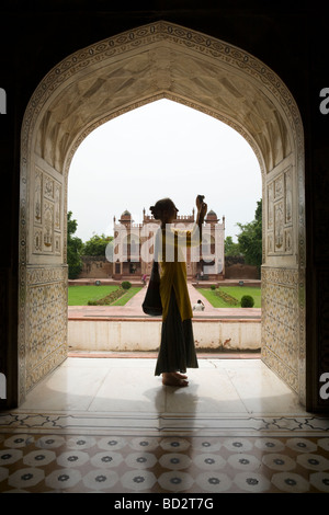 Western touriste photographiant dans une arche d'Itmad-ud-Daulah mausolée. L'Agra. L'Inde. Banque D'Images