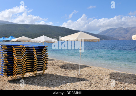 Plage de l'île Ionienne grecque Kefalonia avec transats parasols en attente Banque D'Images