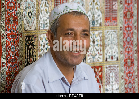 Textiles ouzbek vendeur dans l'un des dômes commerciaux à Boukhara Ouzbékistan Banque D'Images