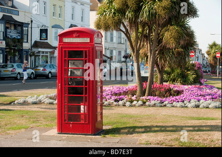 Cabine téléphonique rouge britannique traditionnel, avec des lits de fleurs colorées Walmer, dans le Kent Banque D'Images