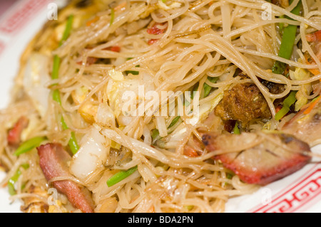 Nouilles de riz fin et plat avec des tranches de rôti de porc et légumes au restaurant chinois Banque D'Images