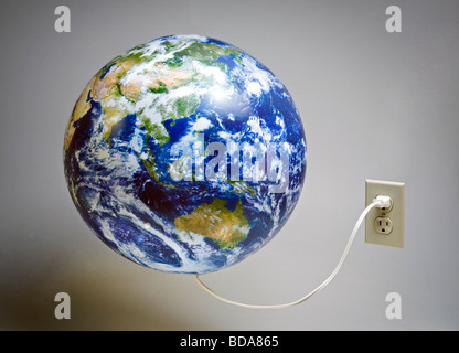 Toujours d'un monde monde branché dans une prise électrique Banque D'Images