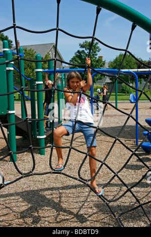 Girl cordes d'escalade à l'aire de jeux. Banque D'Images