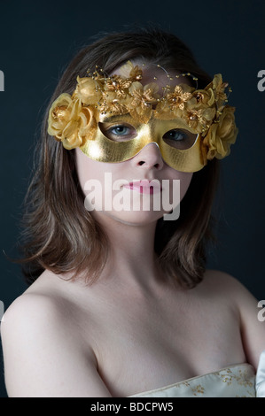 Portrait d'un adolescent portant un masque de mascarade debout Banque D'Images