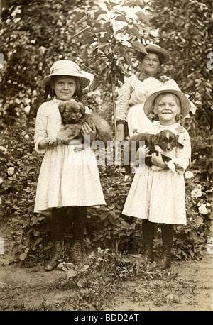 Deux soeurs avec leurs chiots Banque D'Images