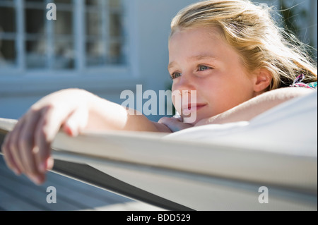 Girl resting on a deck chair Banque D'Images
