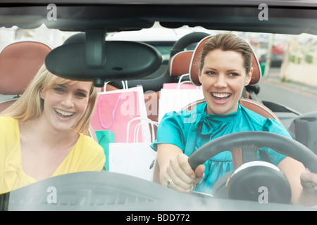 Deux femmes assises dans une voiture après le magasinage Banque D'Images