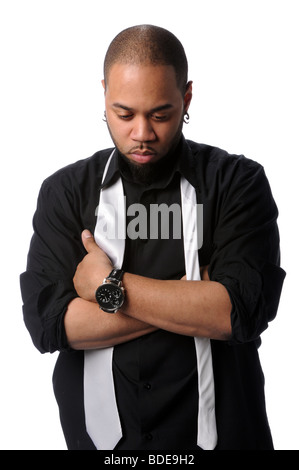 Young African American man with arms crossed looking down Banque D'Images
