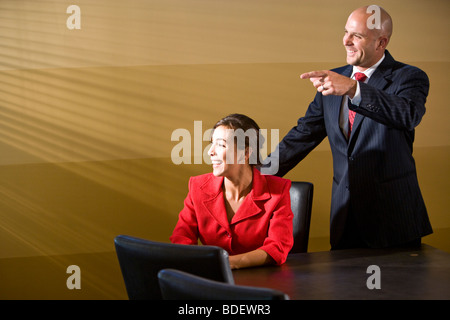 Two businesspeople smiling in boardroom Banque D'Images